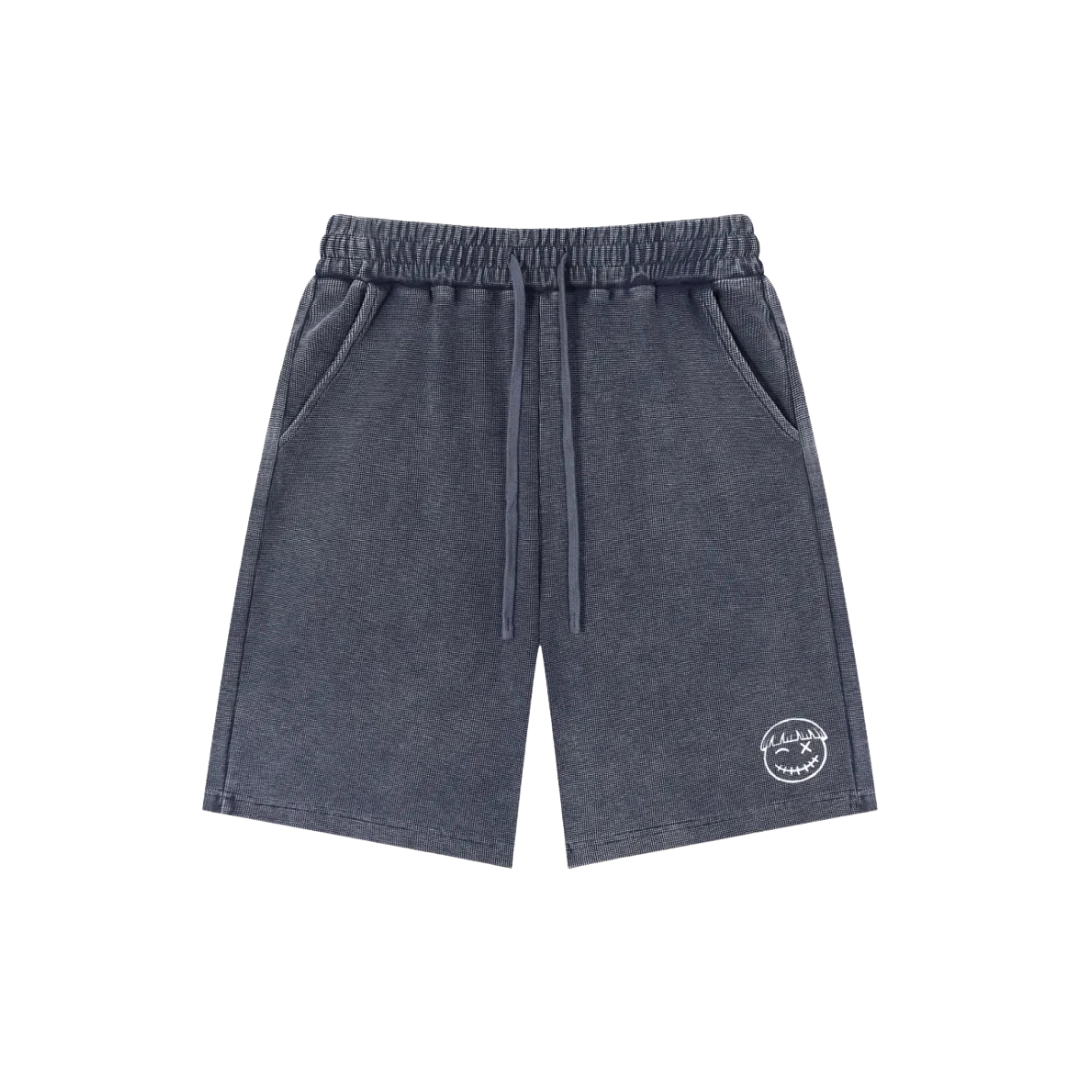 Asphalt blue snow wash shorts — front, tonal PM smiley patch on the hip