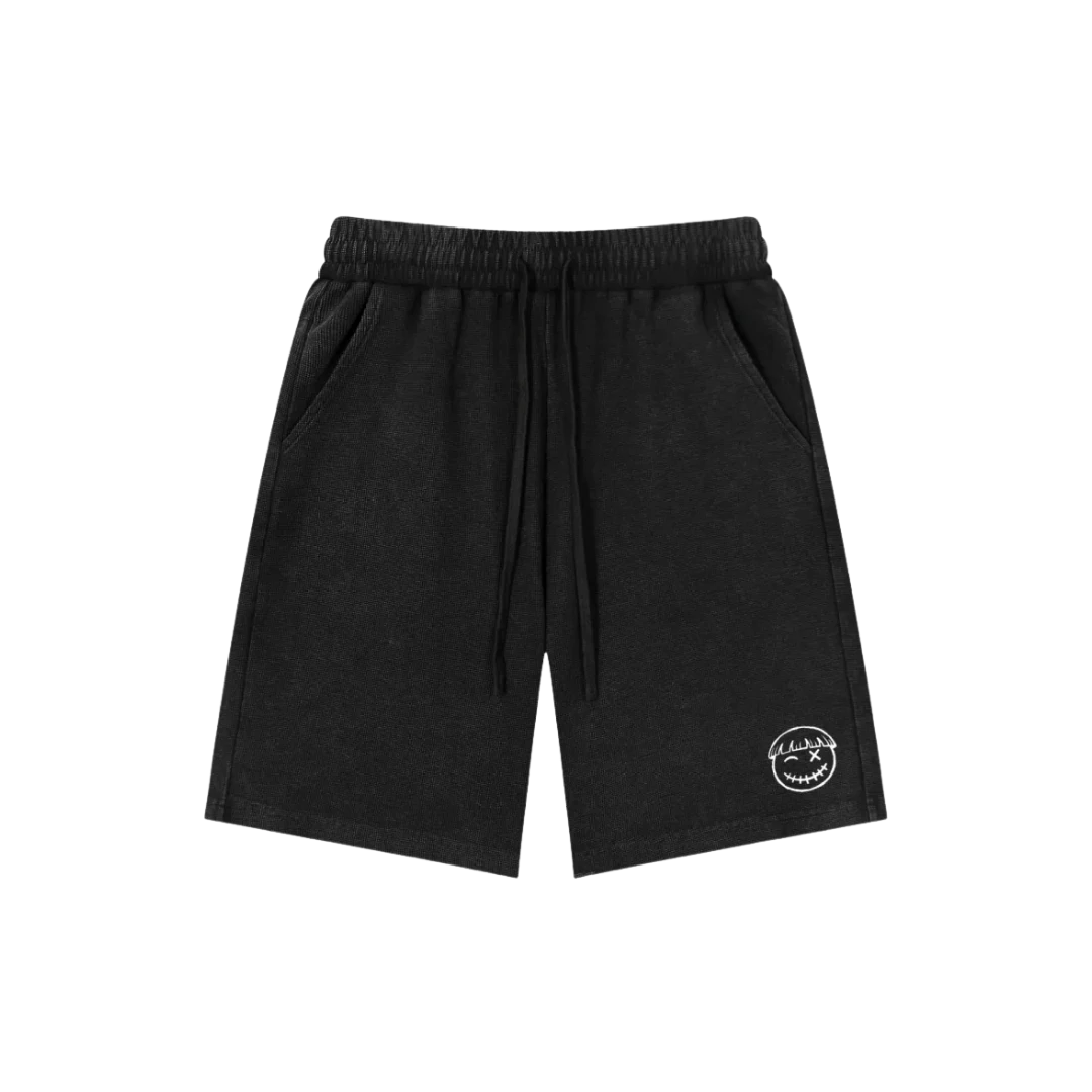 Black mamba snow wash shorts — front, tonal PM smiley patch on the hip