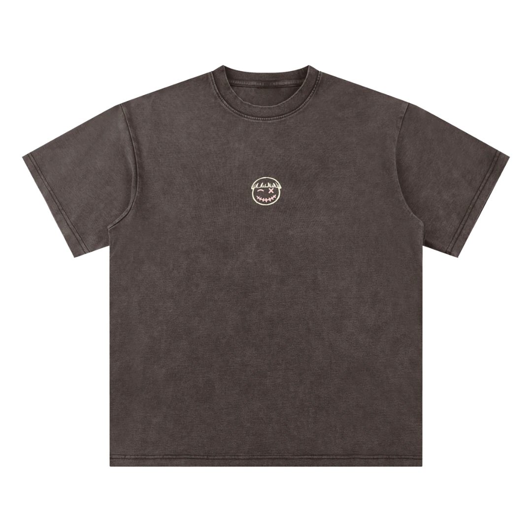 Coffee brown final cut tee — front, PM smiley framed in a small pink square on the chest