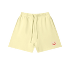 Lemon yellow sweatshorts — front, tonal PM smiley patch on the hip