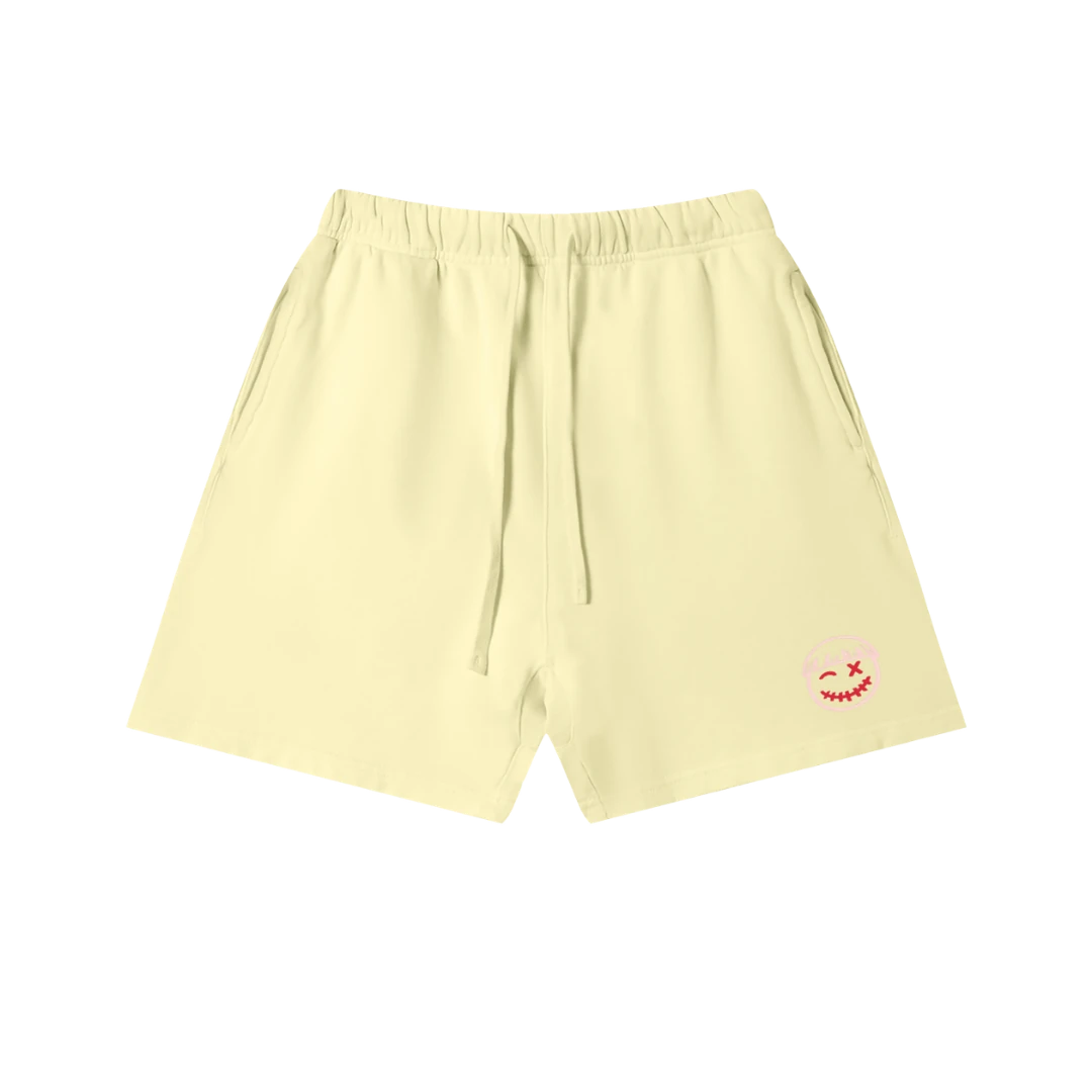 Lemon yellow sweatshorts — front, tonal PM smiley patch on the hip