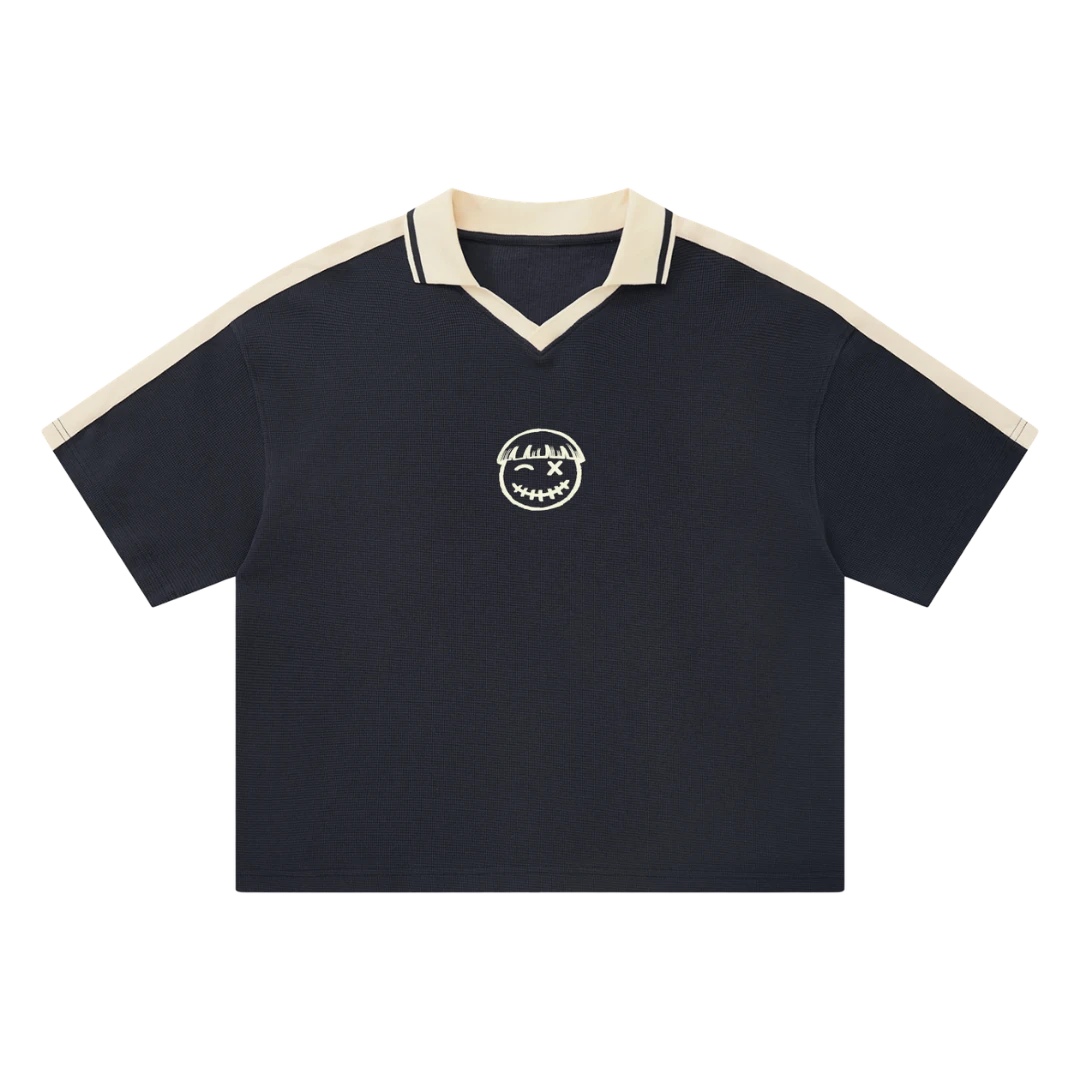 Navy waffle knit polo — front, cream tipped collar and shoulder trim