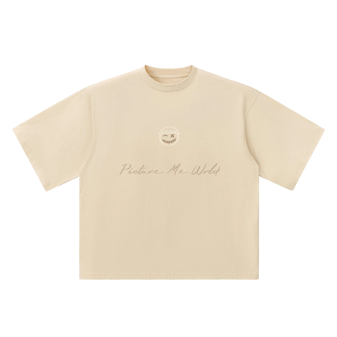 Oversized washed cotton tee — front, PM face logo and "Picture Me Wrld" script print