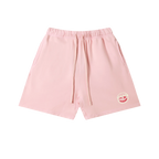Pink cotton sweatshorts — front, tonal PM smiley patch on the hip