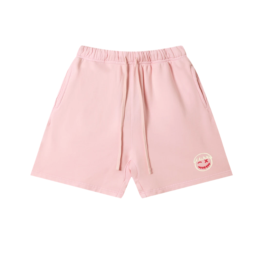 Pink cotton sweatshorts — front, tonal PM smiley patch on the hip